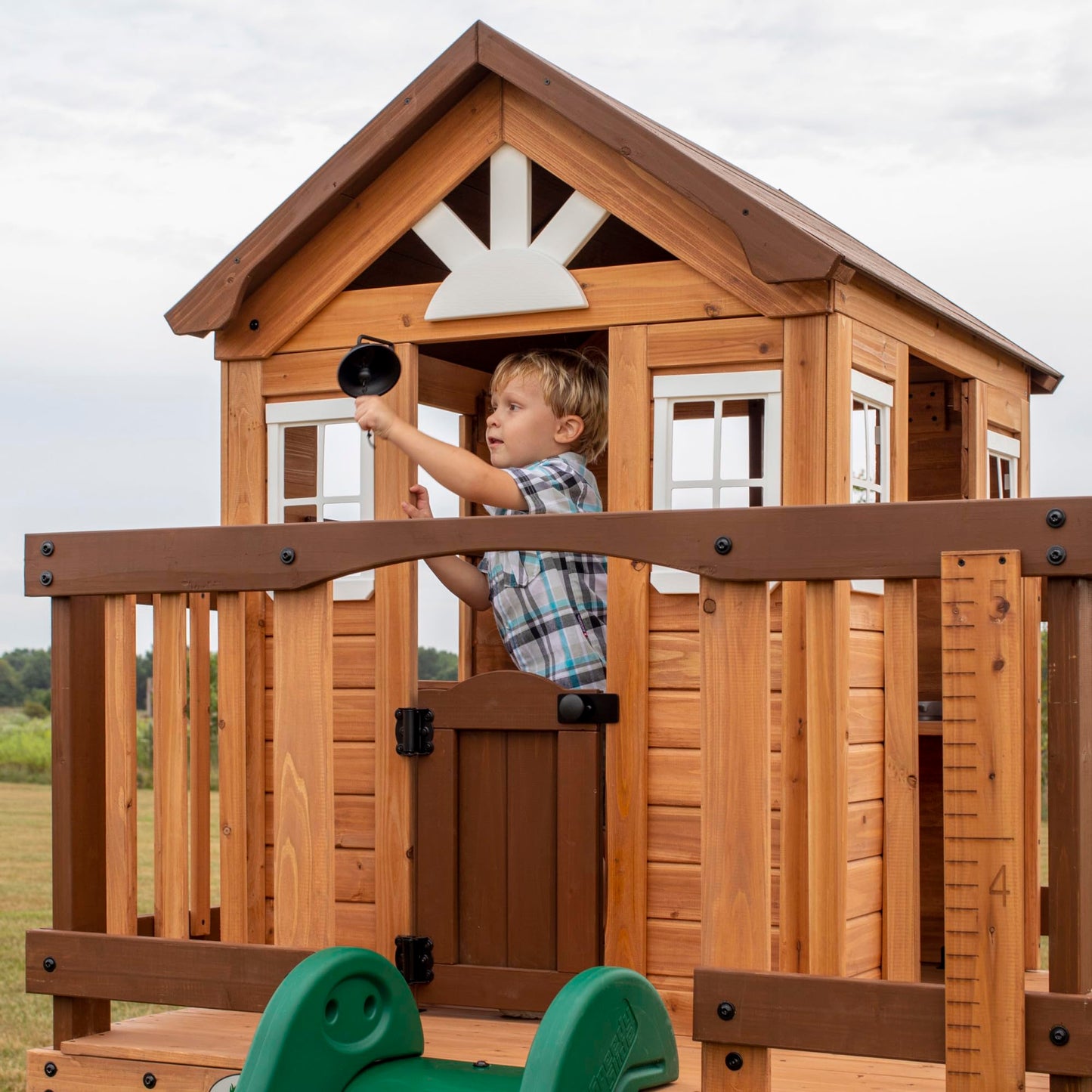 Backyard Discovery Echo Heights Elevated Cedar Wooden Kids Playhouse with Wave Slide, Play Kitchen, Wrap-Around Deck, Flat-Step Ladder, Half Door, Windows, Bell, and Growth Chart for Outdoor Play