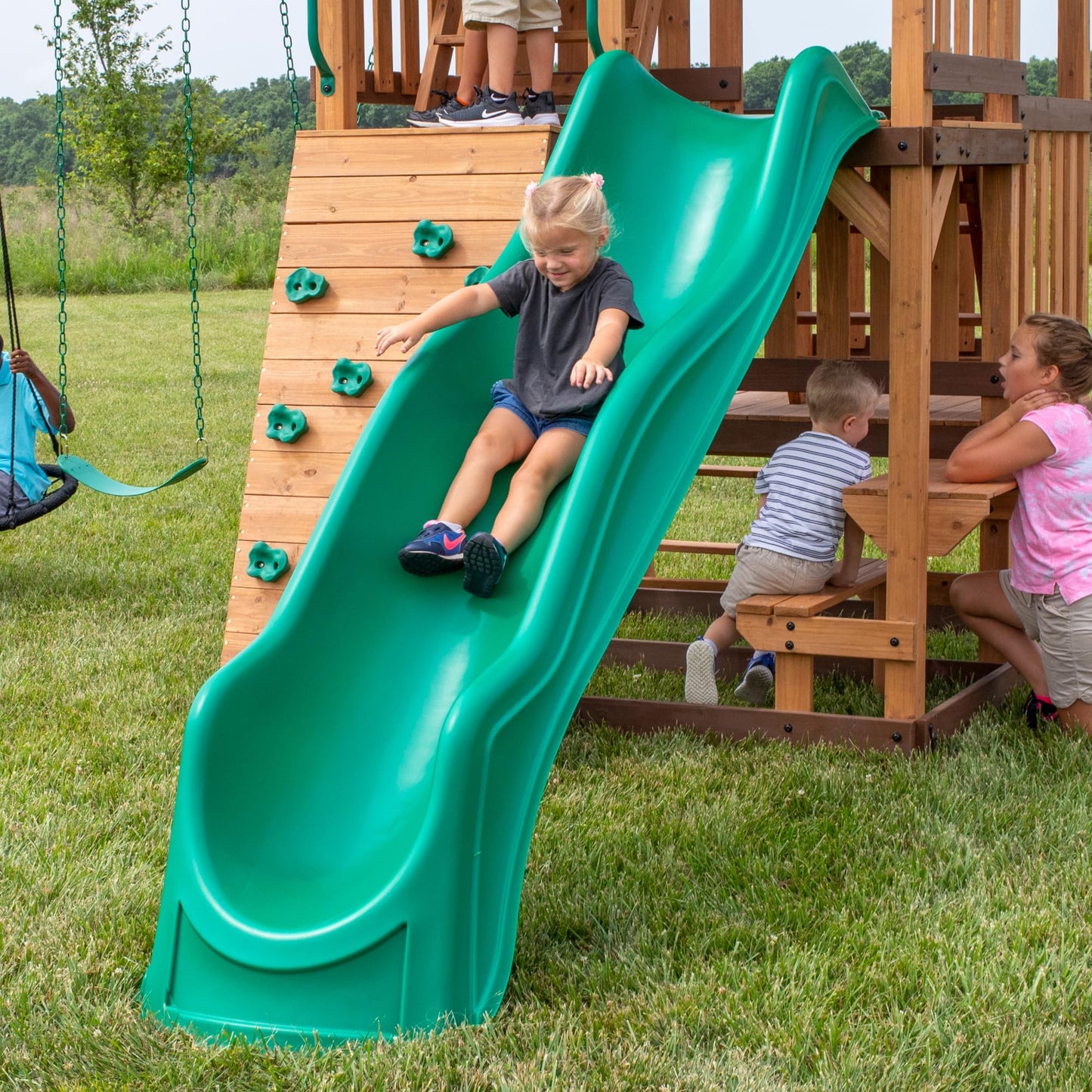 Backyard Discovery Highlander Cedar Wood Swing Set with Wave Slide, Three-Story Clubhouse, Rock Wall, Picnic Table, Belt Swings, Web Swing, Sandbox, Three Ladders, Toy Accessories, Outdoor Playset