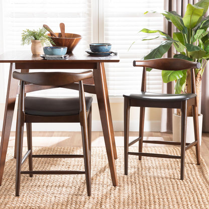 Baxton Studio Eira Counter Stool Set of 2- Walnut Wood Frame Counter-Height Chair with Curved Backrest and Black Faux Leather Seat, Mid-Century Modern Kitchen Island Seating