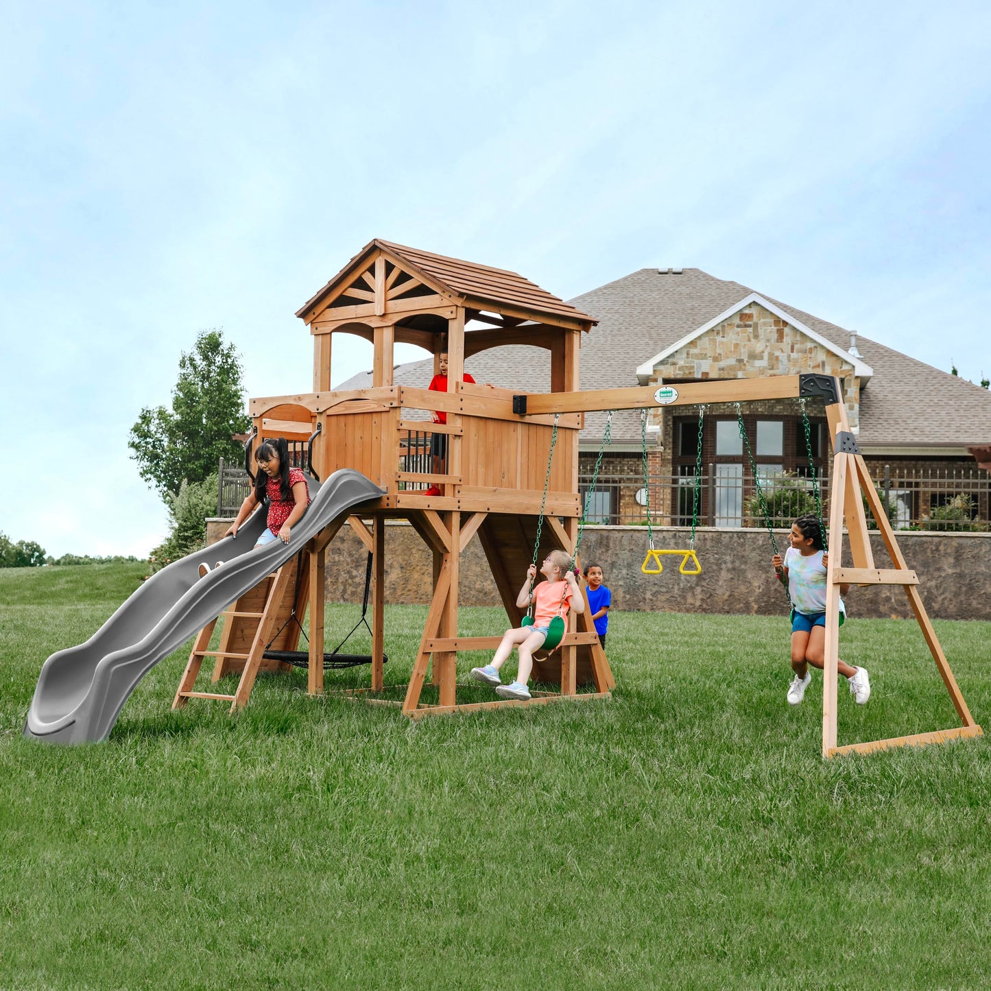 Backyard Discovery Sterling Point Cedar Wood Swing Set with Wave Slide, Raised Clubhouse, Wooden Bridge, Rock Wall, Belt Swings, Web Swing, Trapeze, Balcony, Climbing Wall, Ladder, Outdoor Playset